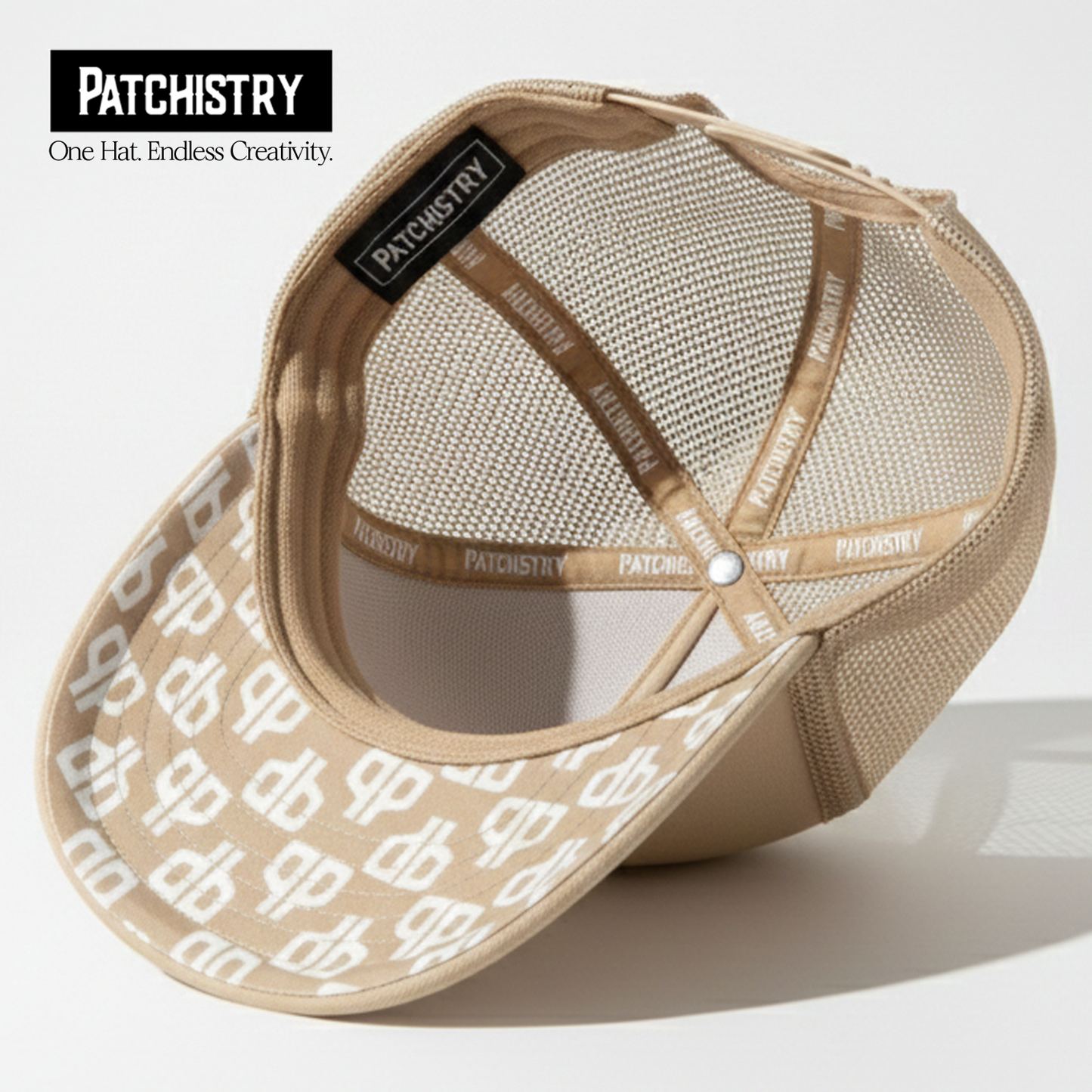 Khaki trucker hat under-brim patch detail — patches attach to the brim too