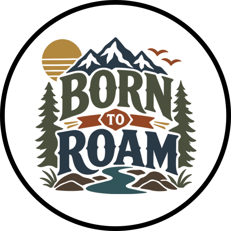 Born to Roam patch — circular badge with mountains, pines, a river, and a setting sun